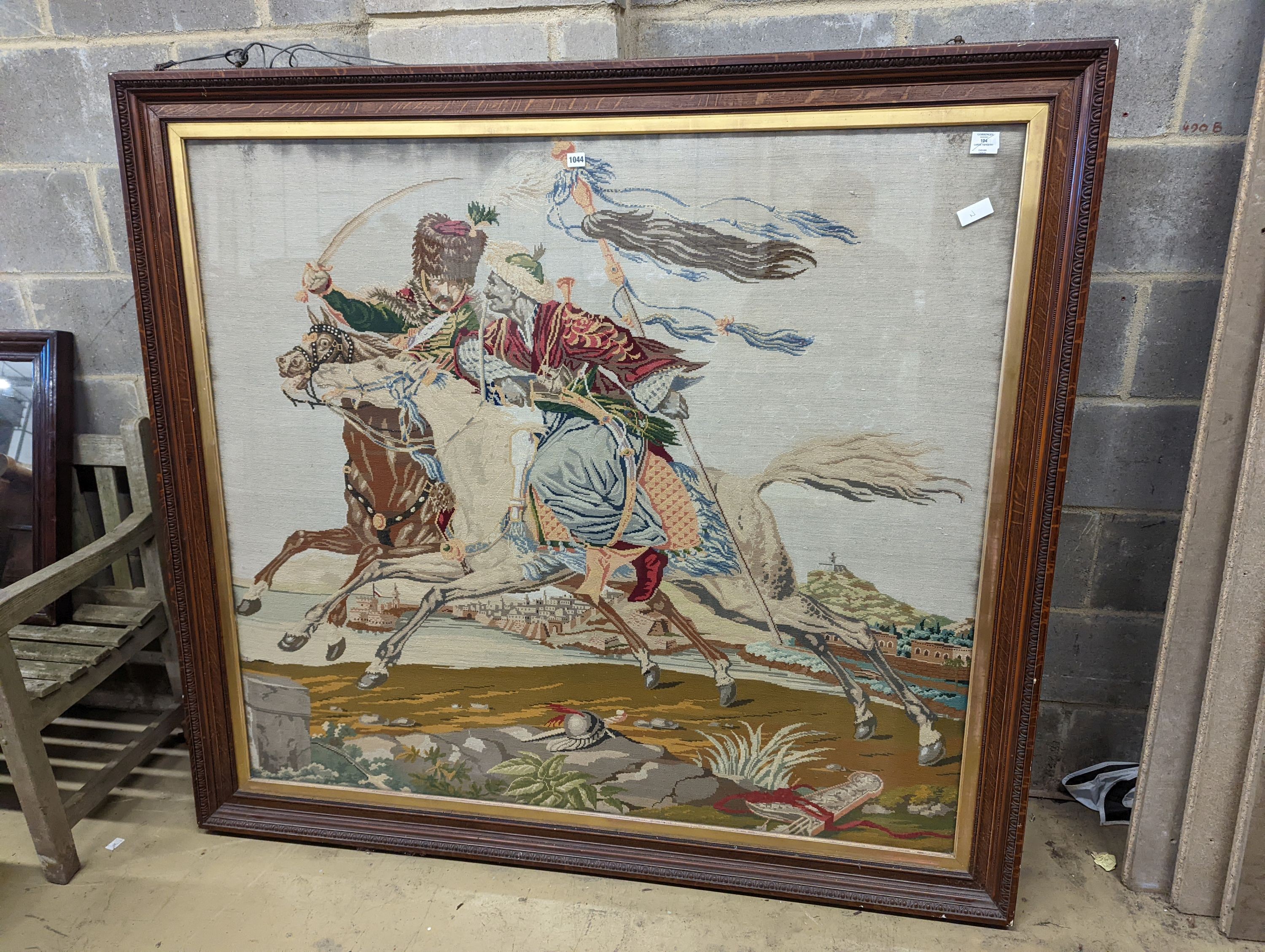 A large Victorian polychrome tapestry panel depicting a Hussar mounted and Moor in combat (oak framed), panel 145 x 130cm
